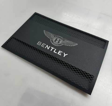 Laser cut paper sleeve for Bentley's MAG product, featuring intricate patterns and precise laser cutting.